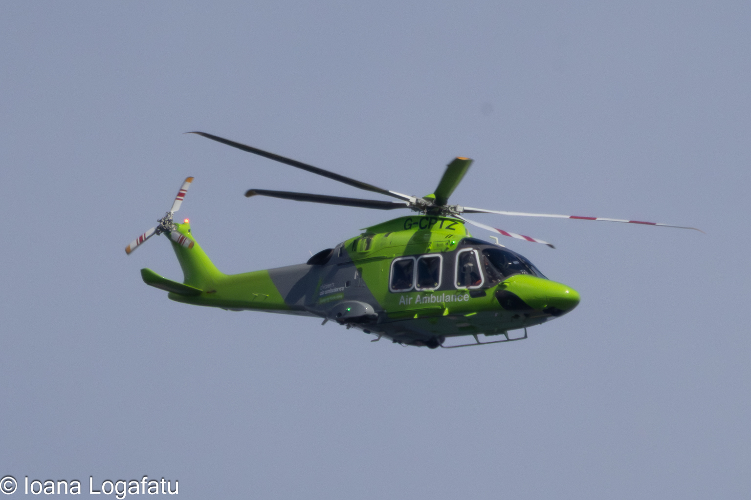 Helicopter gliding through a clear blue sky